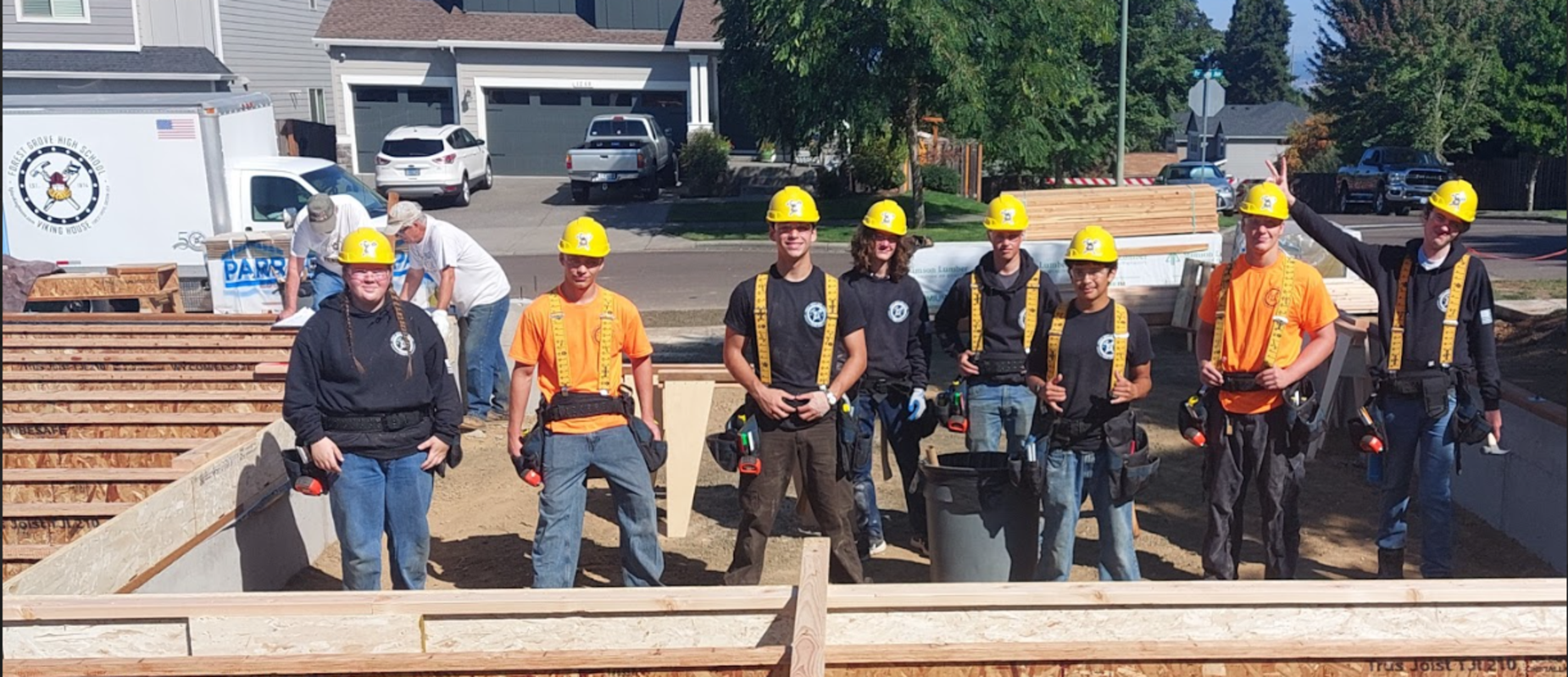 Group of construction workers wearing hard hats on a building site.