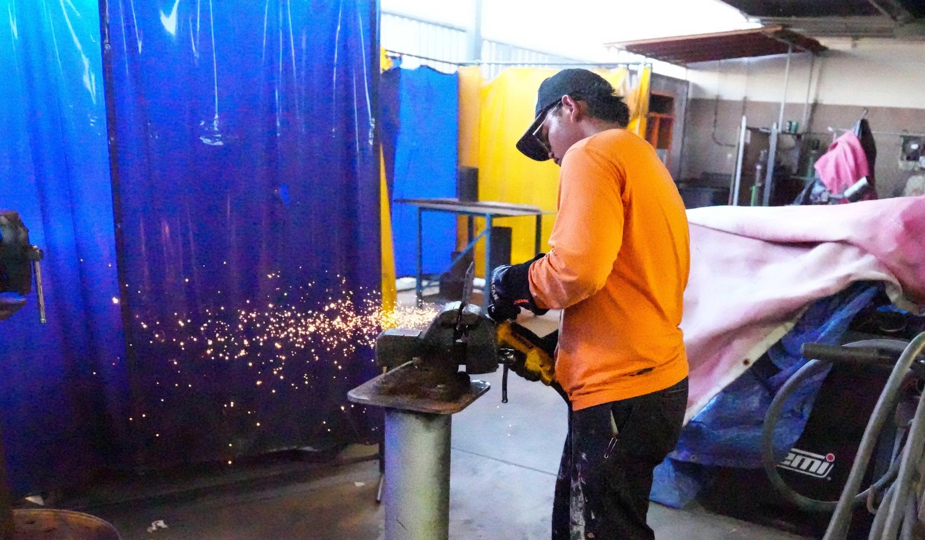 Student welding in class