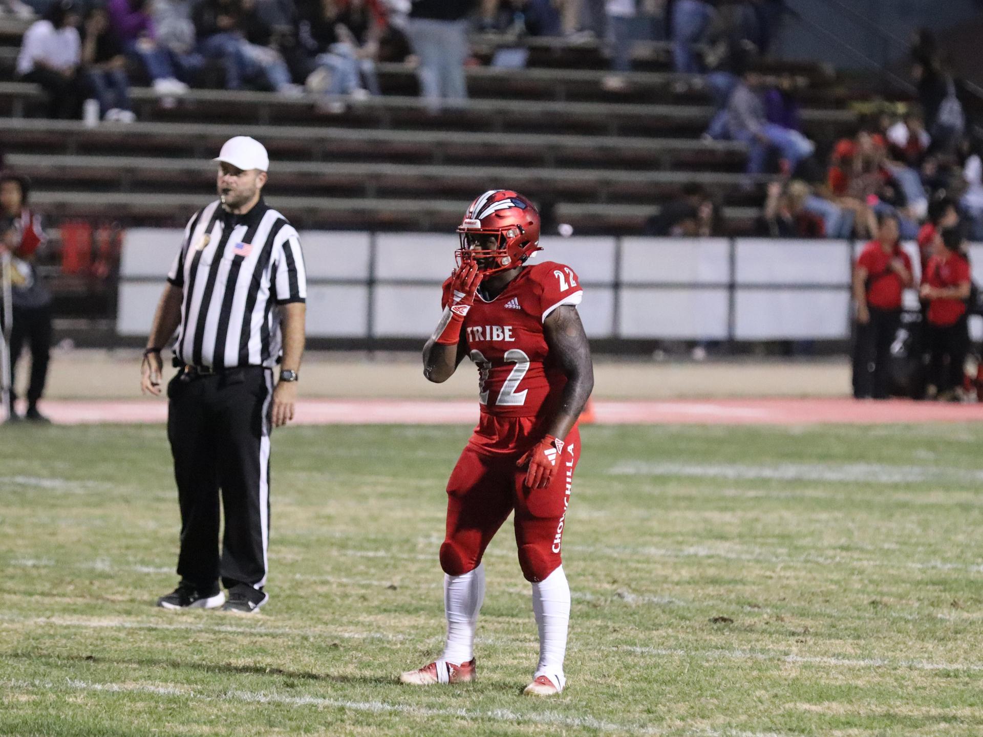 varsity football players in action against Riverdale