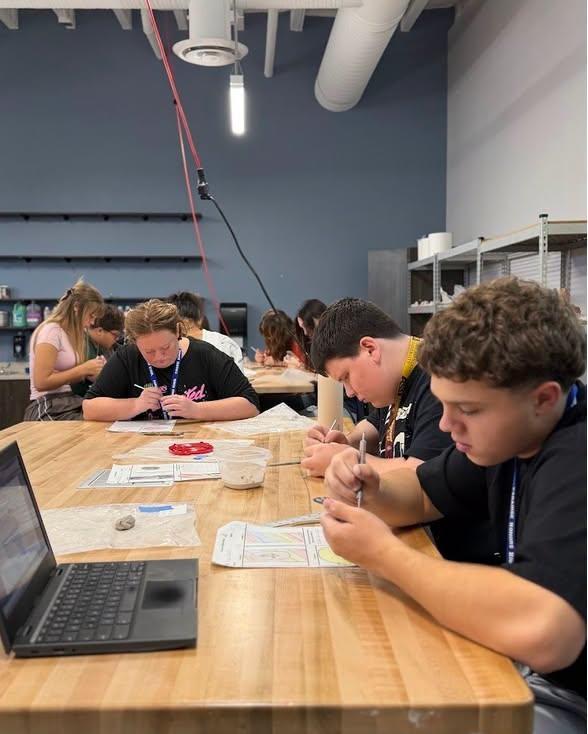 photo of student playing with clay