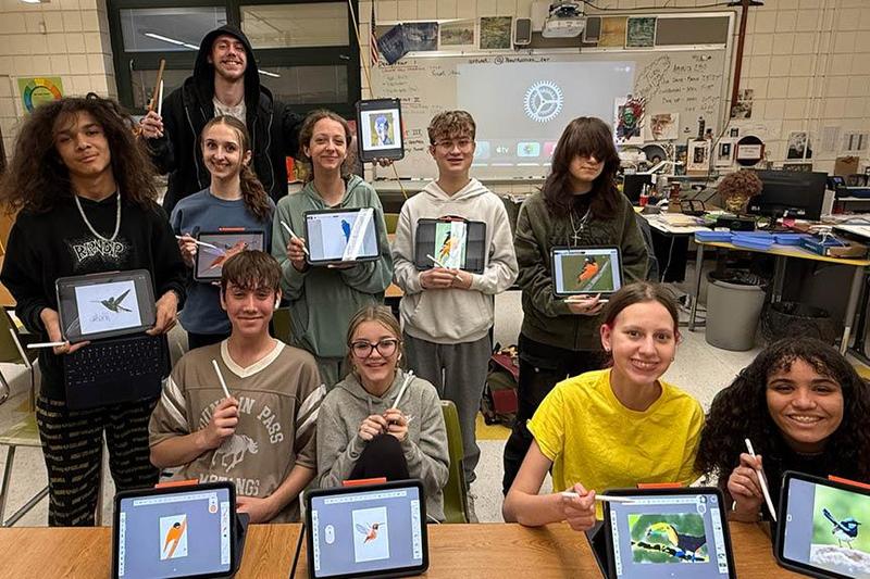 students show the new art class styluses with the art they have created