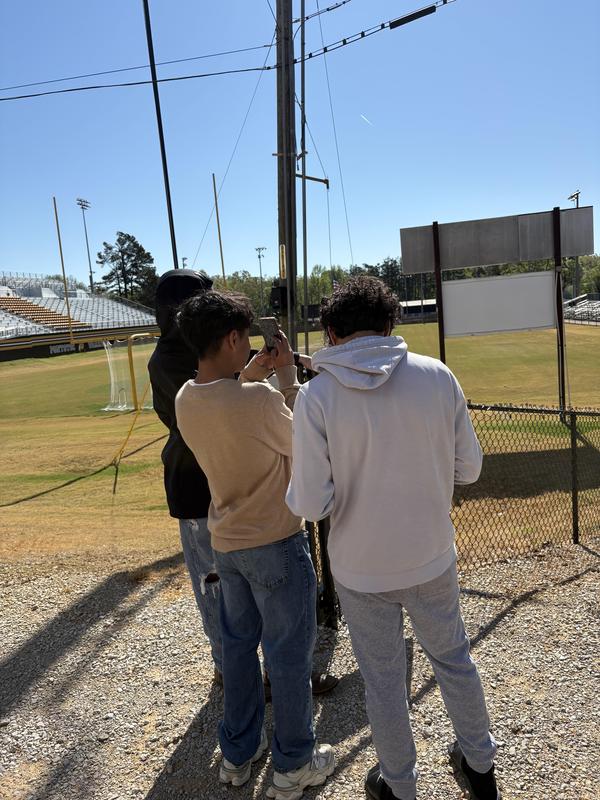 Students looking for Polygons near the football field