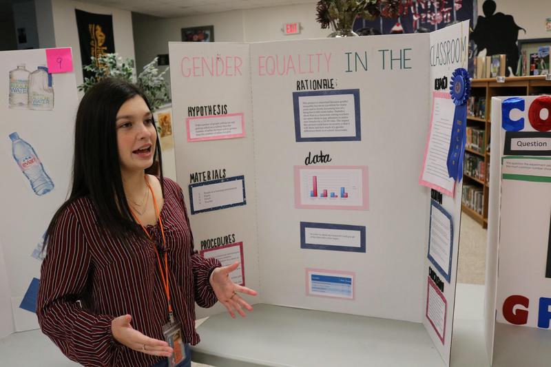 Female student standing in front of her science project