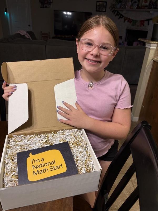 Ellie Carpenter holding a box with awards