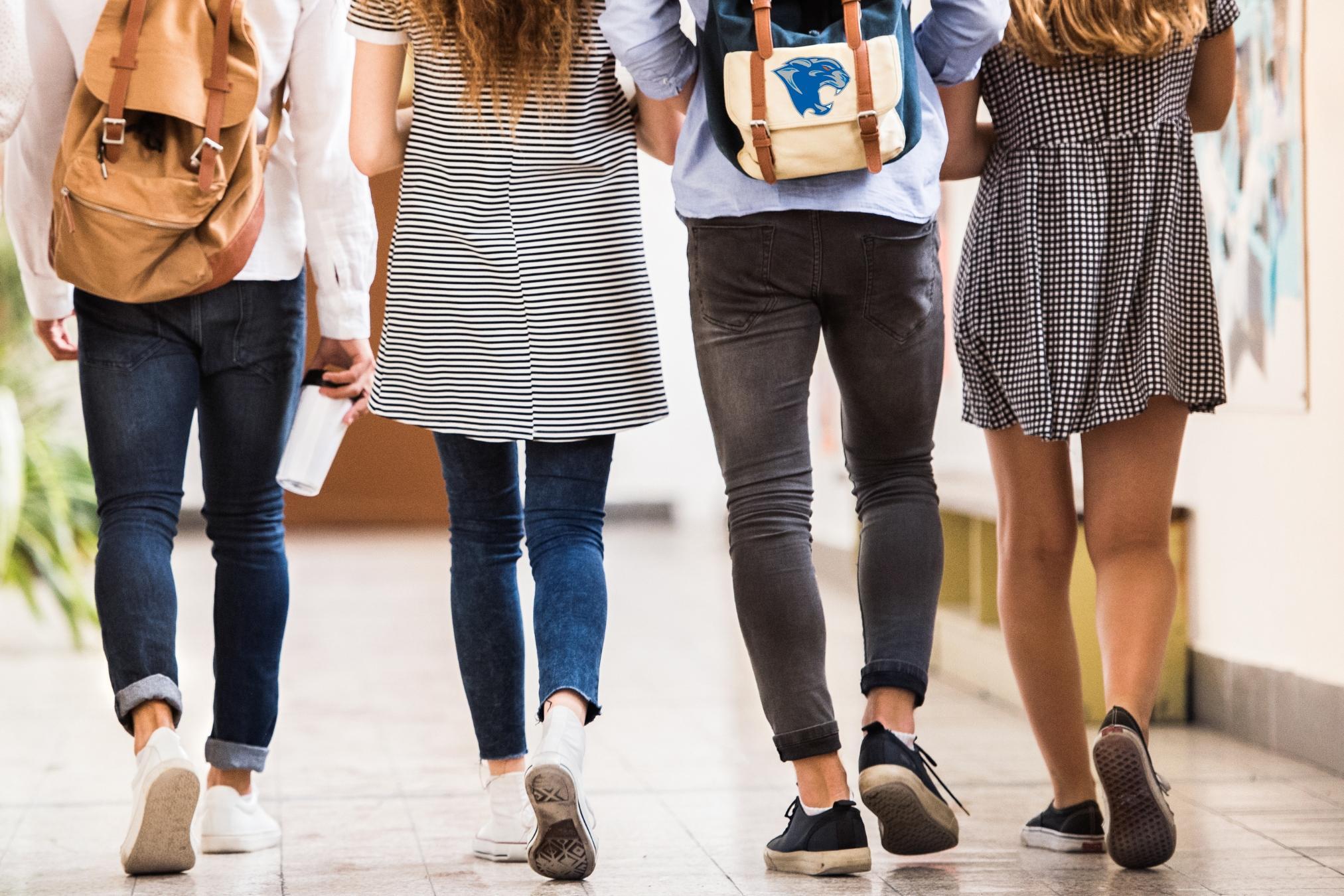 four students walking away together