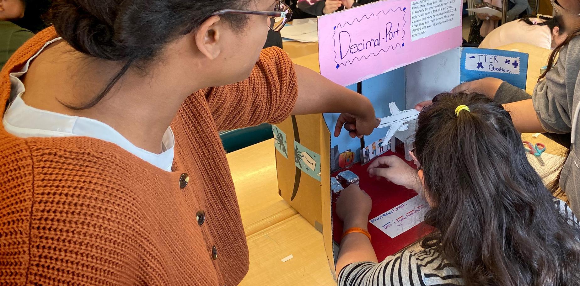 Students engaging with a classroom project display.
