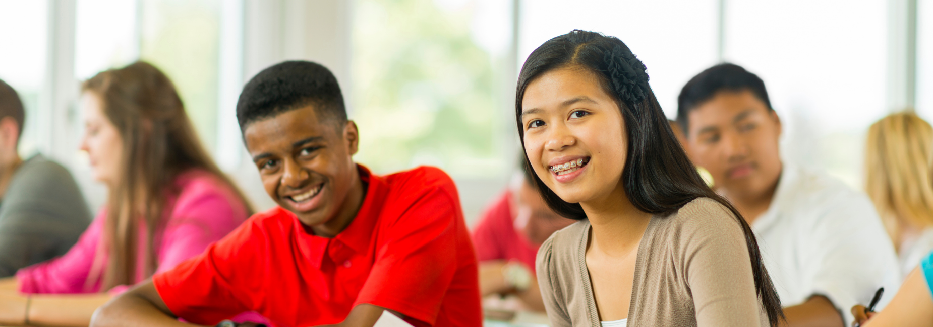 teens in class, two are in focus with others in the background out of focus