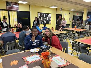 Student and staff member at table