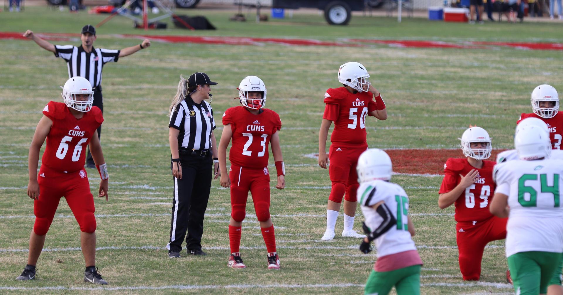  junior varsity football players in action against riverdale