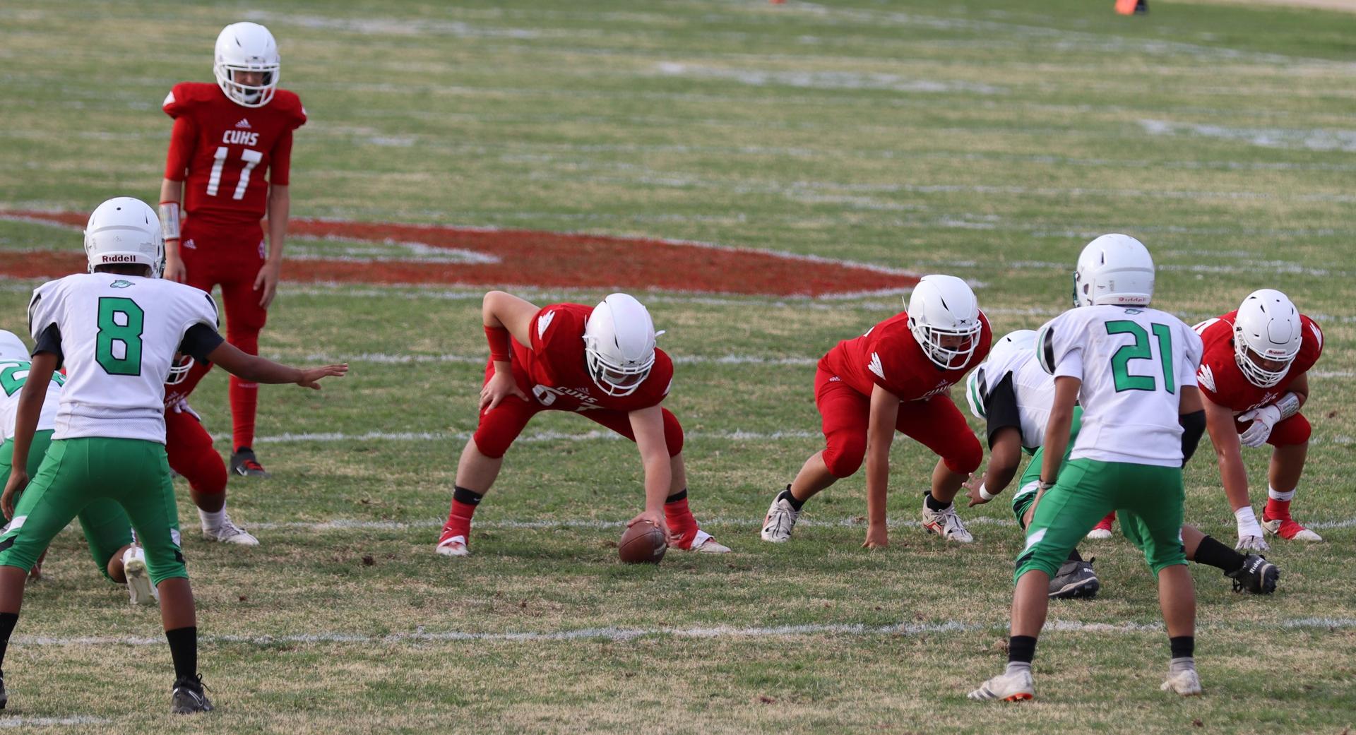  junior varsity football players in action against riverdale