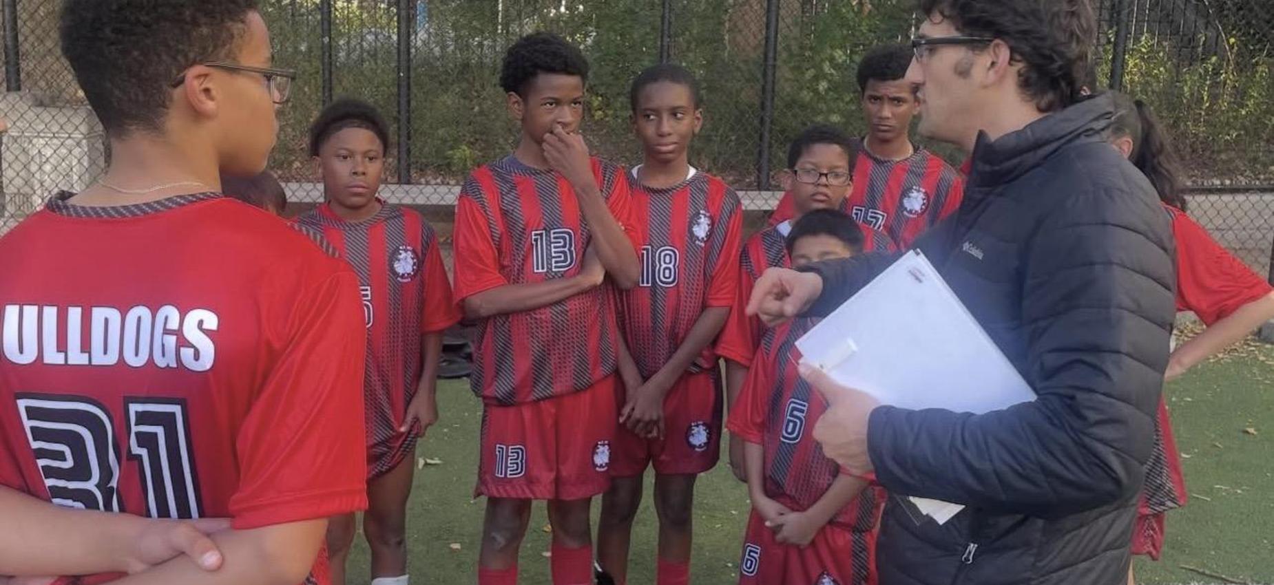 Coach Haley shares gameplan with Soccer team.