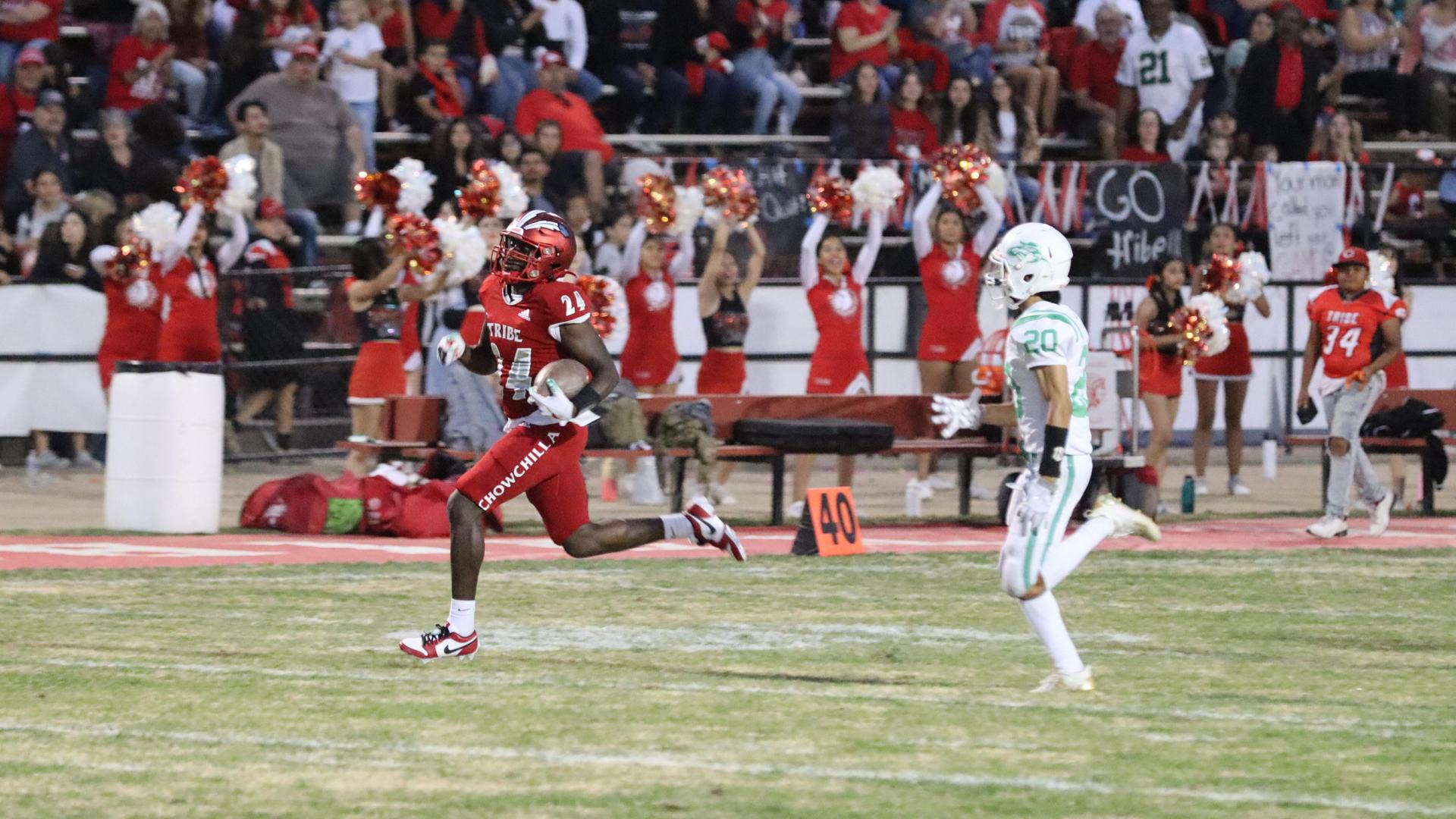 varsity football players in action against Riverdale