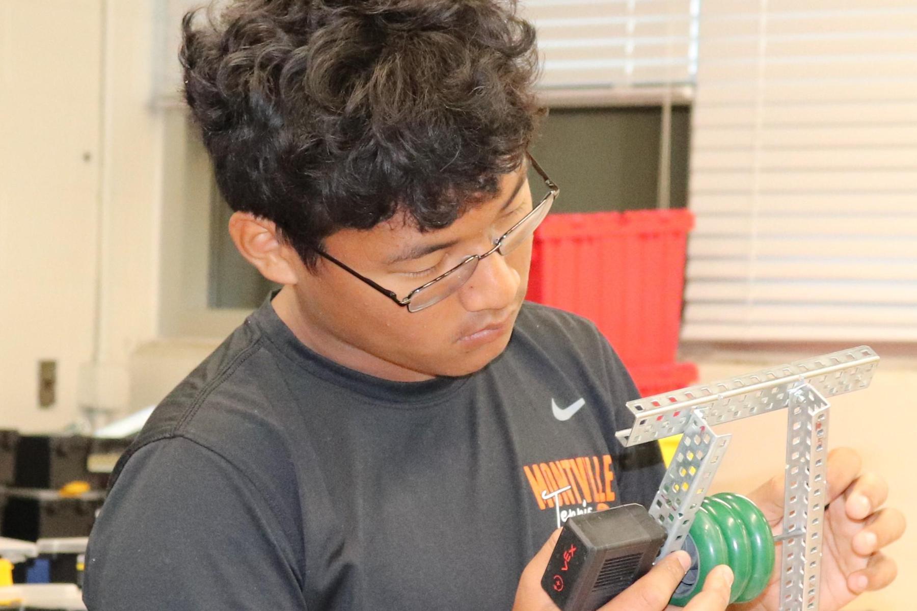 MHS student building and testing robots