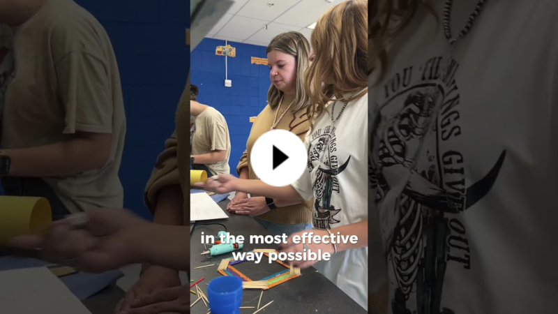YouTube thumbnail of a student explaining a project to an instructor. A flat octagon of colored popsicles sits on a countertop in front of them.