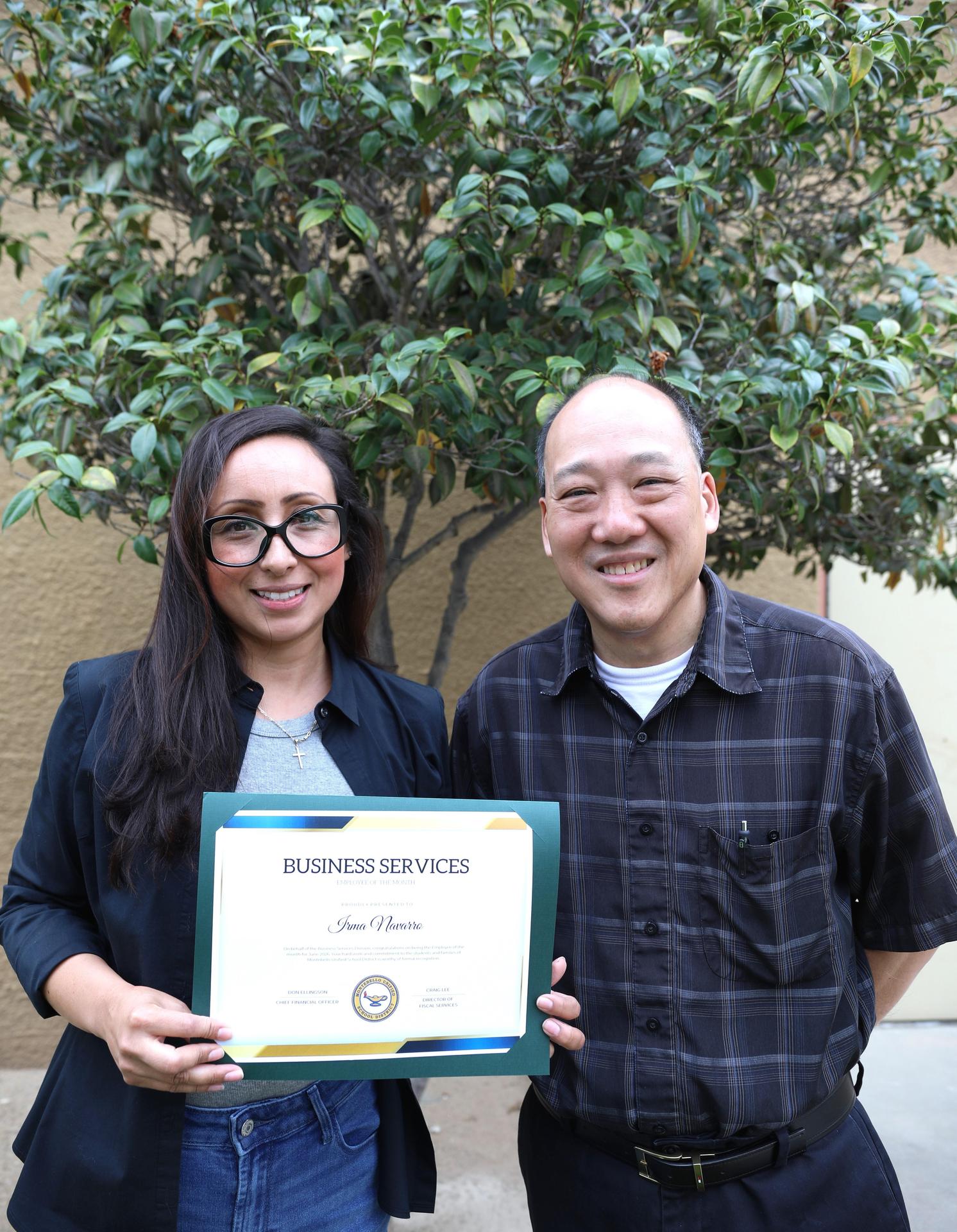 Picture of employee holding certificate