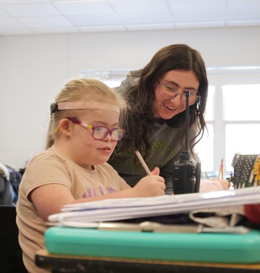 student working with teacher