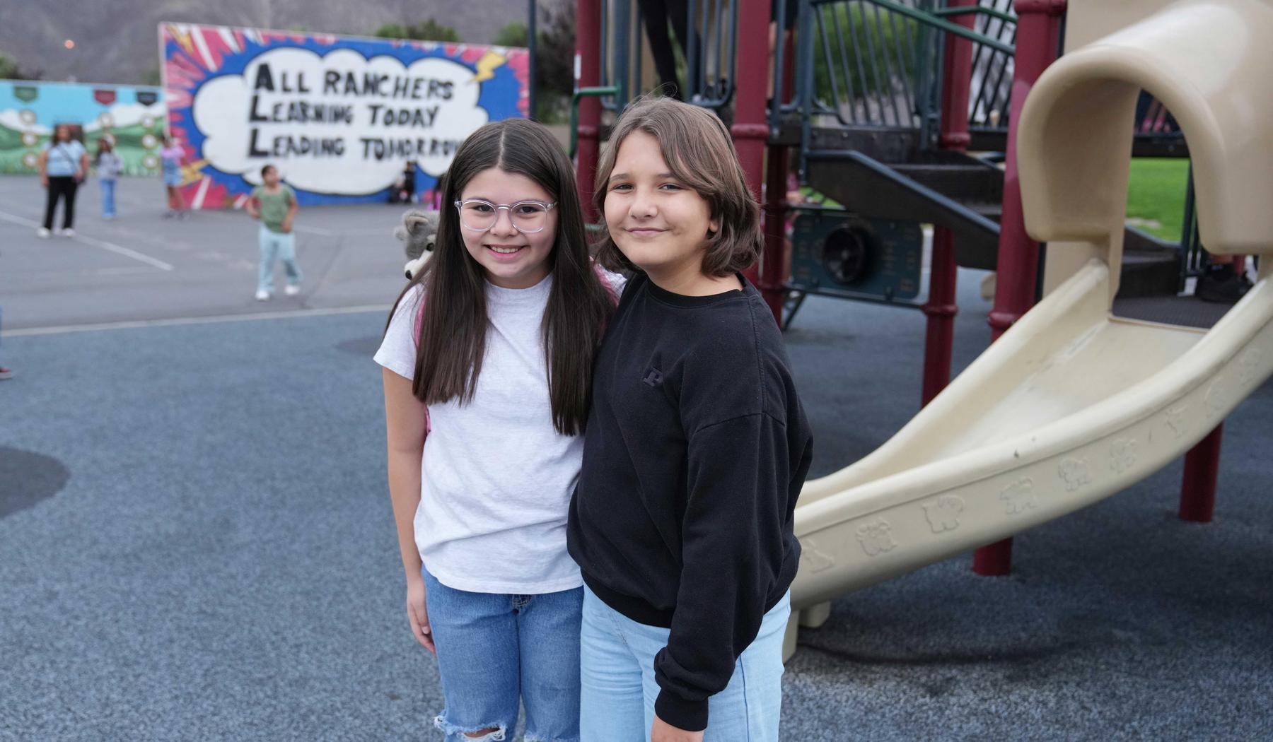 two smiling girls on playground