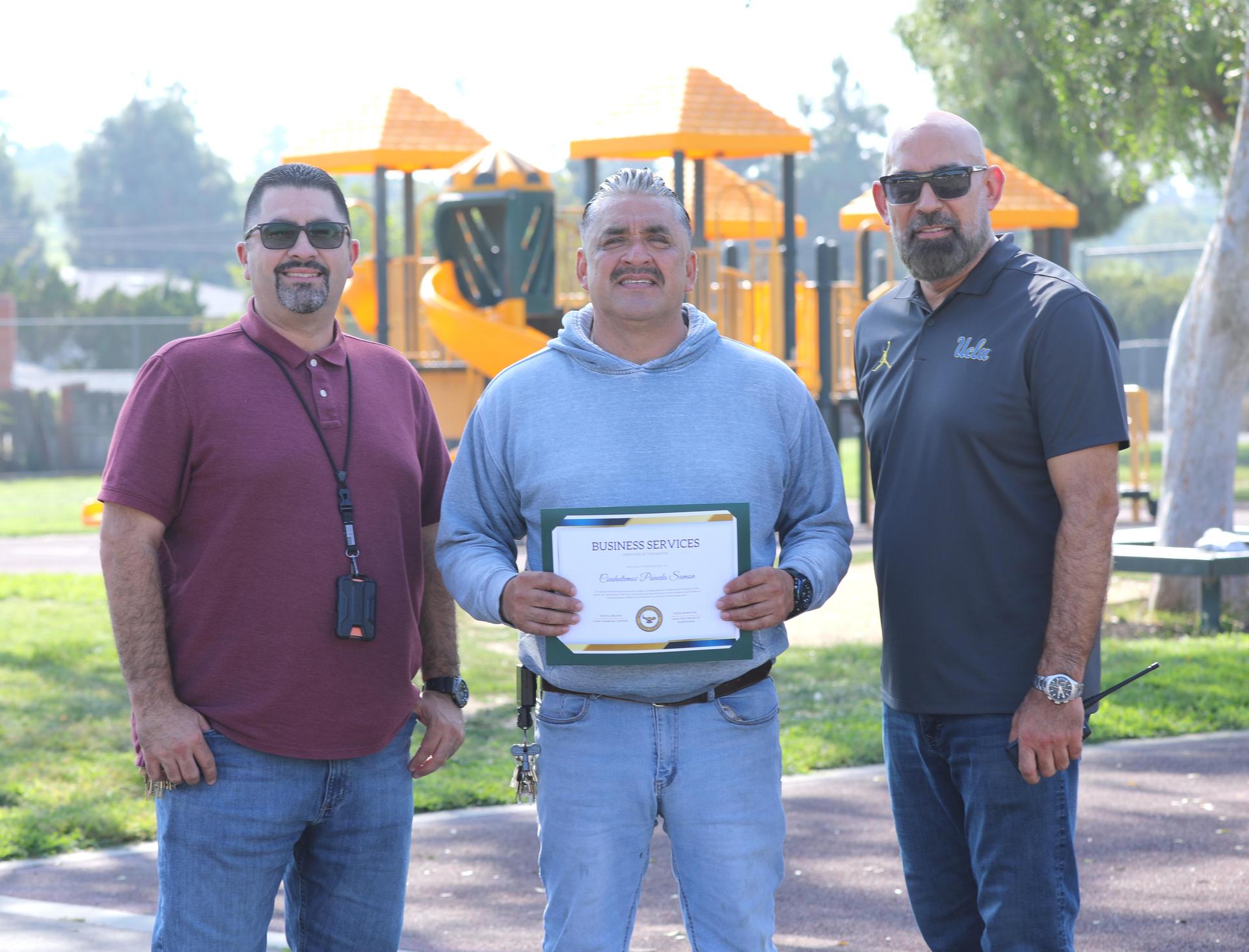 Picture of employee holding certificate