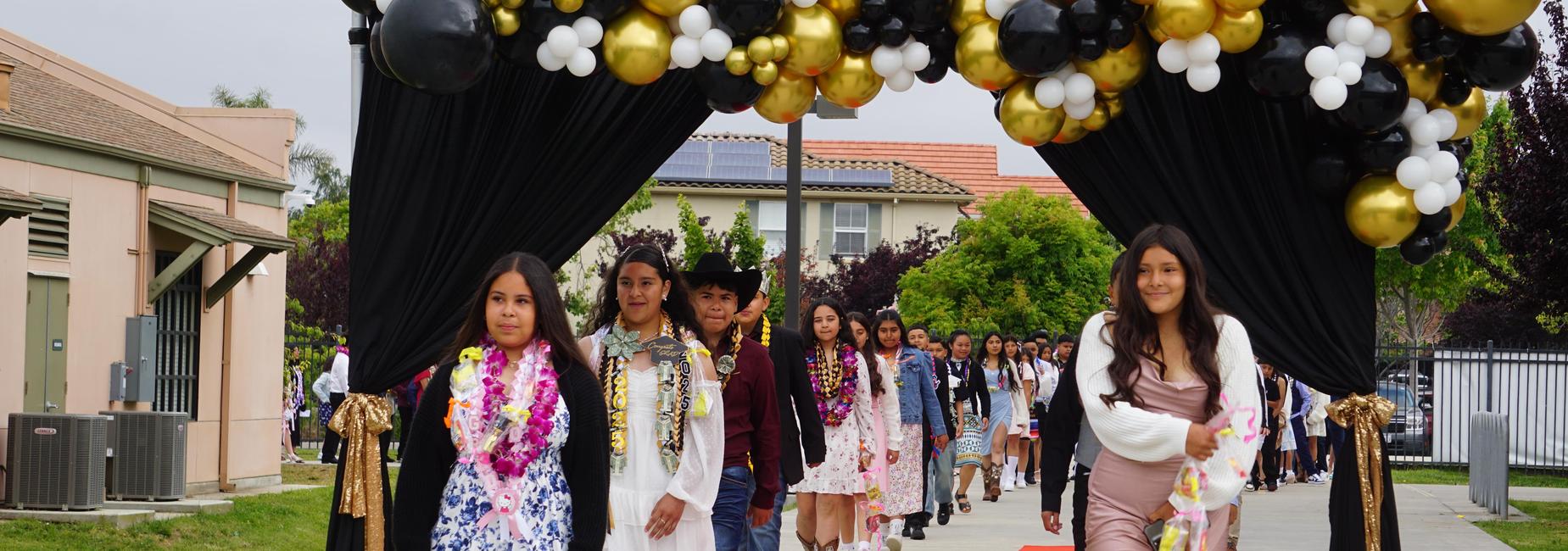 Students walking in the promotion ceremony at Monte Bella Elementary