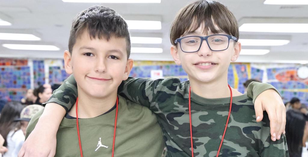 Two boys with arms around each other