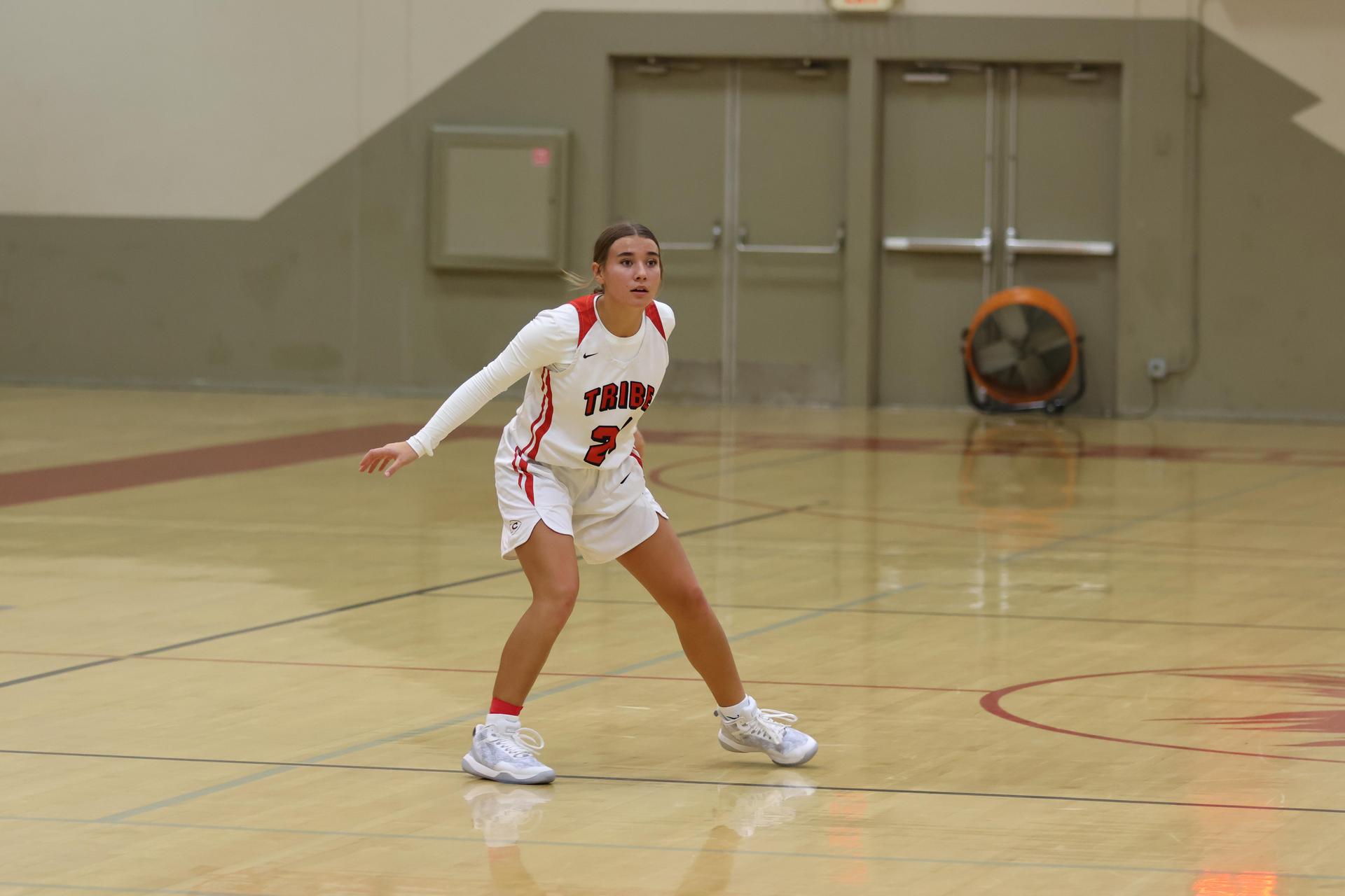 varsity girls playing basketball against mclane