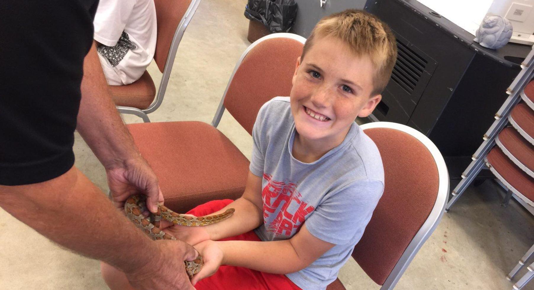 Student holding snake