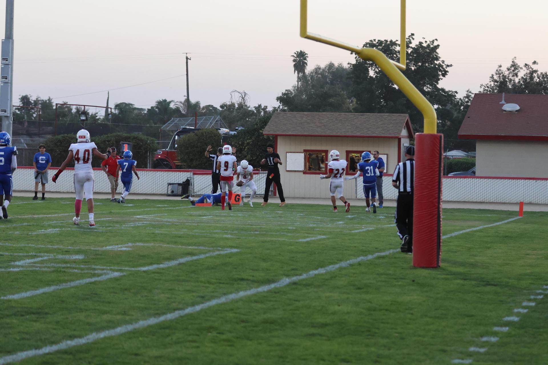 Junior Varsity football players in action against Caruthers