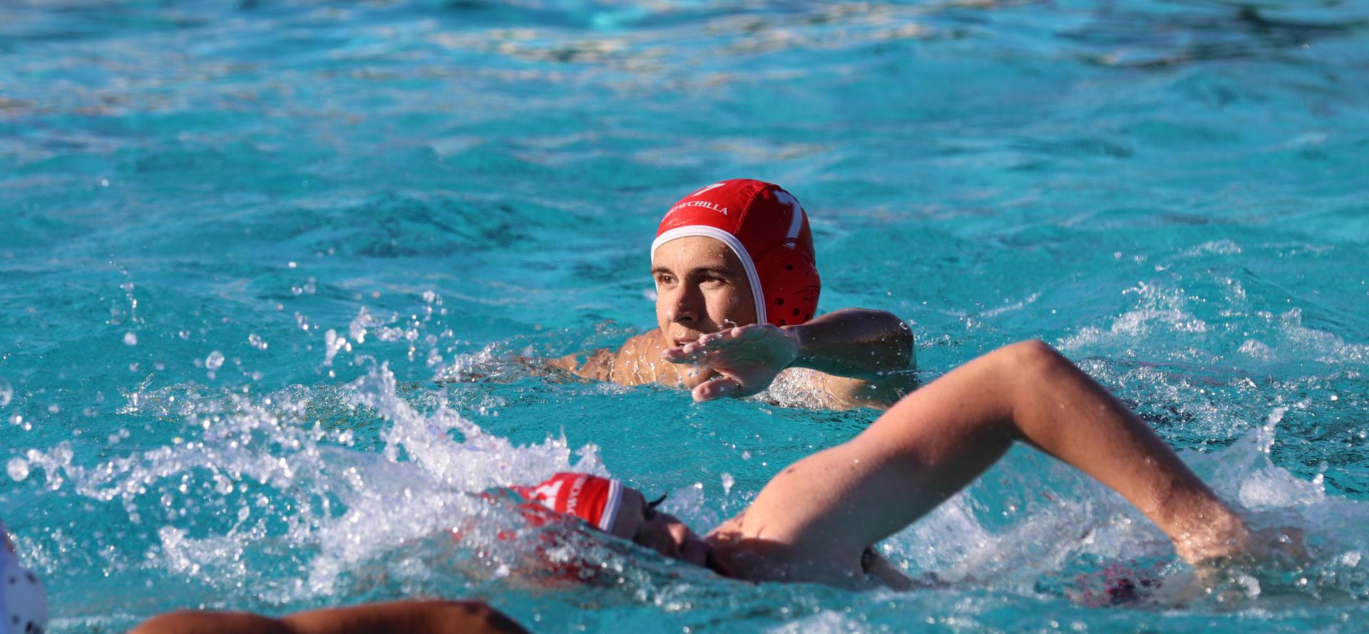boys water polo players in action against hoover