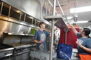 Students help organize the camp kitchen.