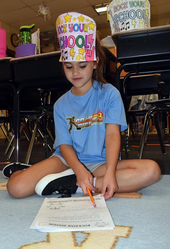 Students completing reading and math activities.
