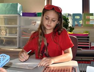 Students completing reading and math activities.