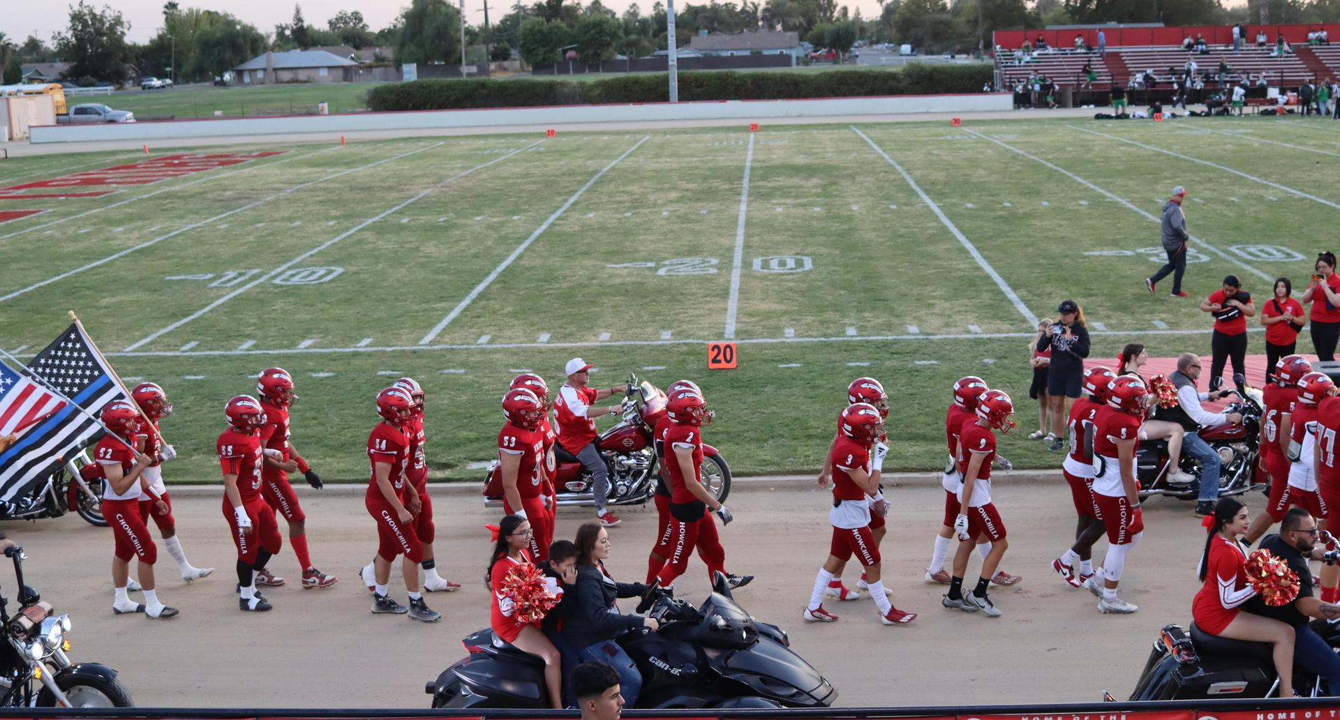 students, staff, and community members enjoying Friday night at the football game