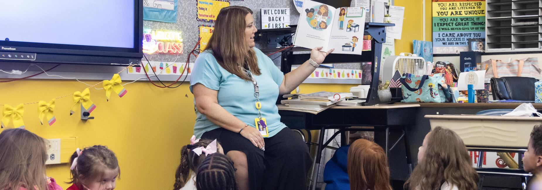 An elementary teacher reads to students