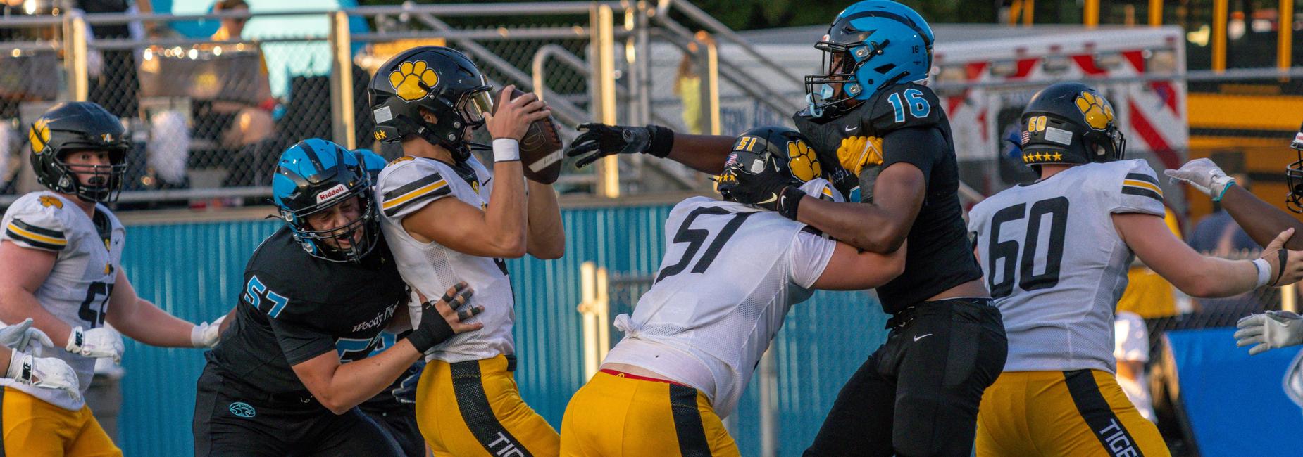 A defensive player takes down the quarterback