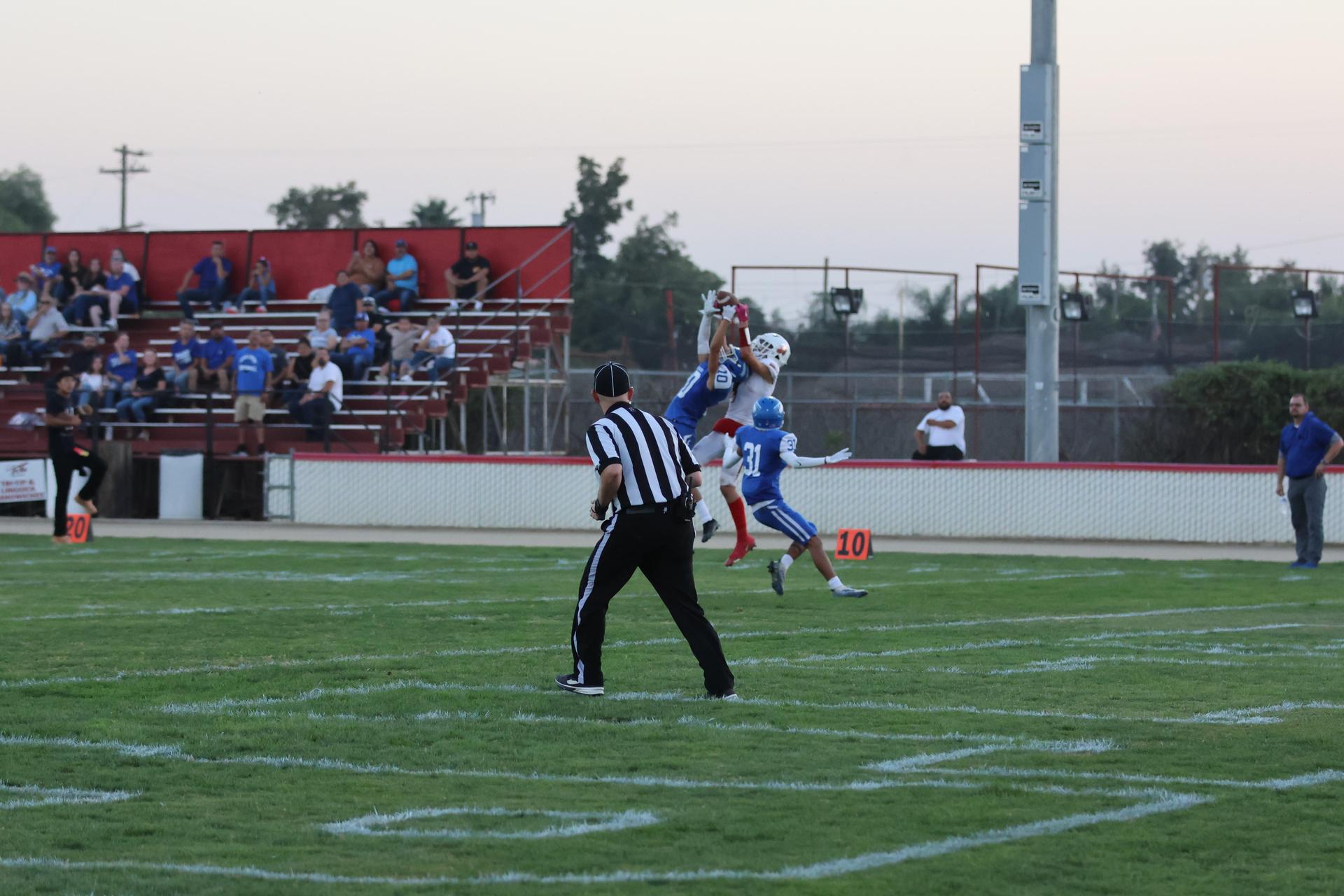 Junior Varsity football players in action against Caruthers
