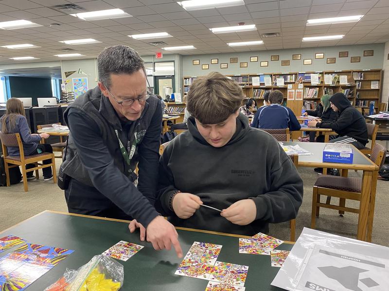 principal and student doing a puzzle