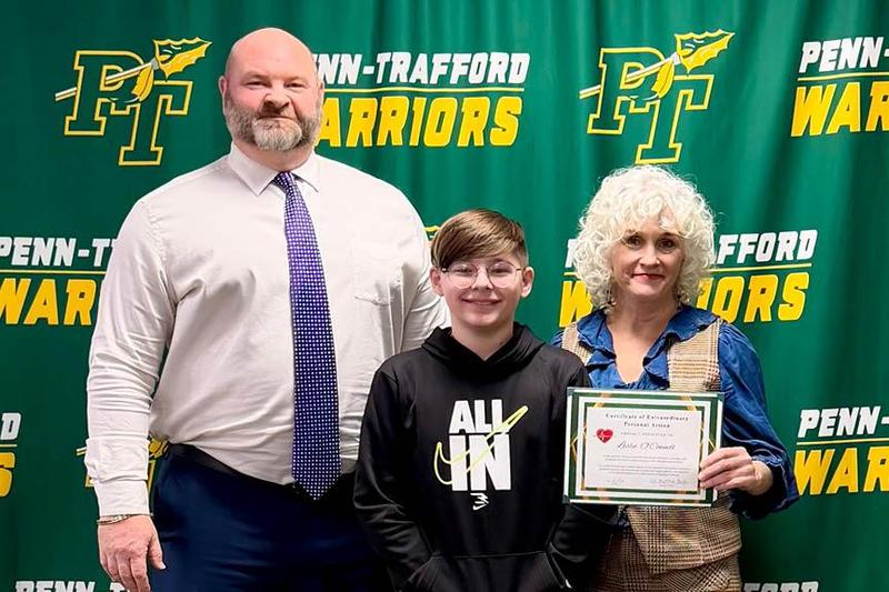 Mr. Roger Sullivan, Mathis Kline, and Leslie O’Connell stand together at the board meeting