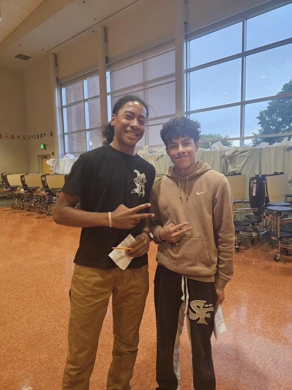 Two Students Standing in Cafeteria