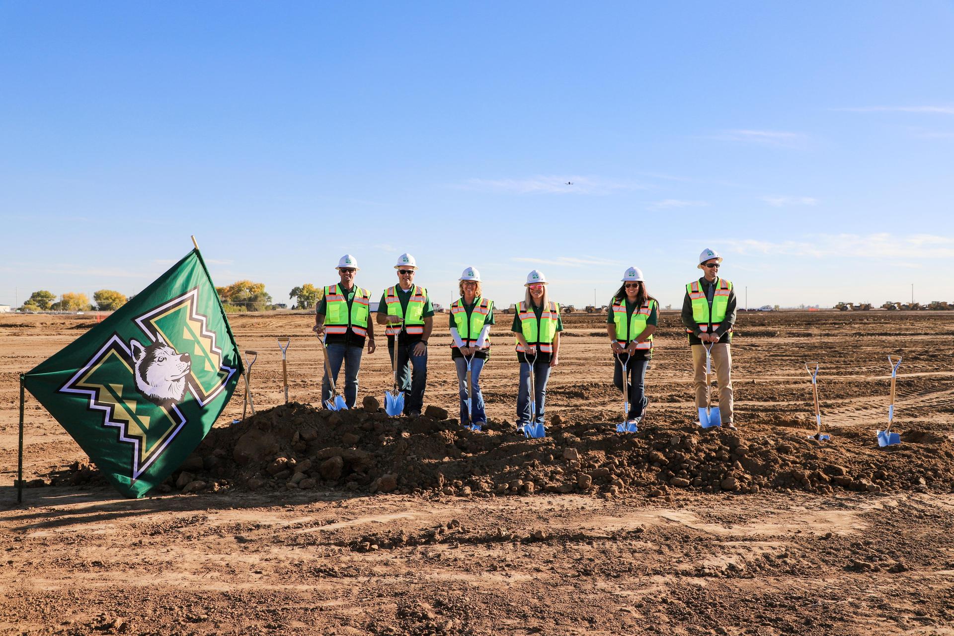 Board members standing at the ground breaking for the k-8 school