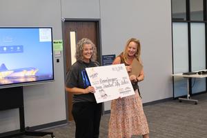 Mrs. Jacquez posing with representative from Texoma Chevy Dealers