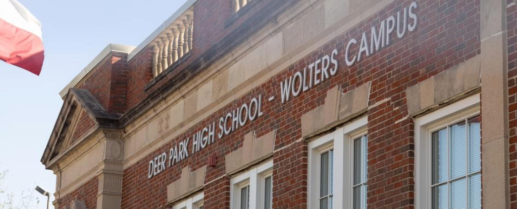 Brick building with "Deer Park High School - Wolters Campus" sign and Texas flag.