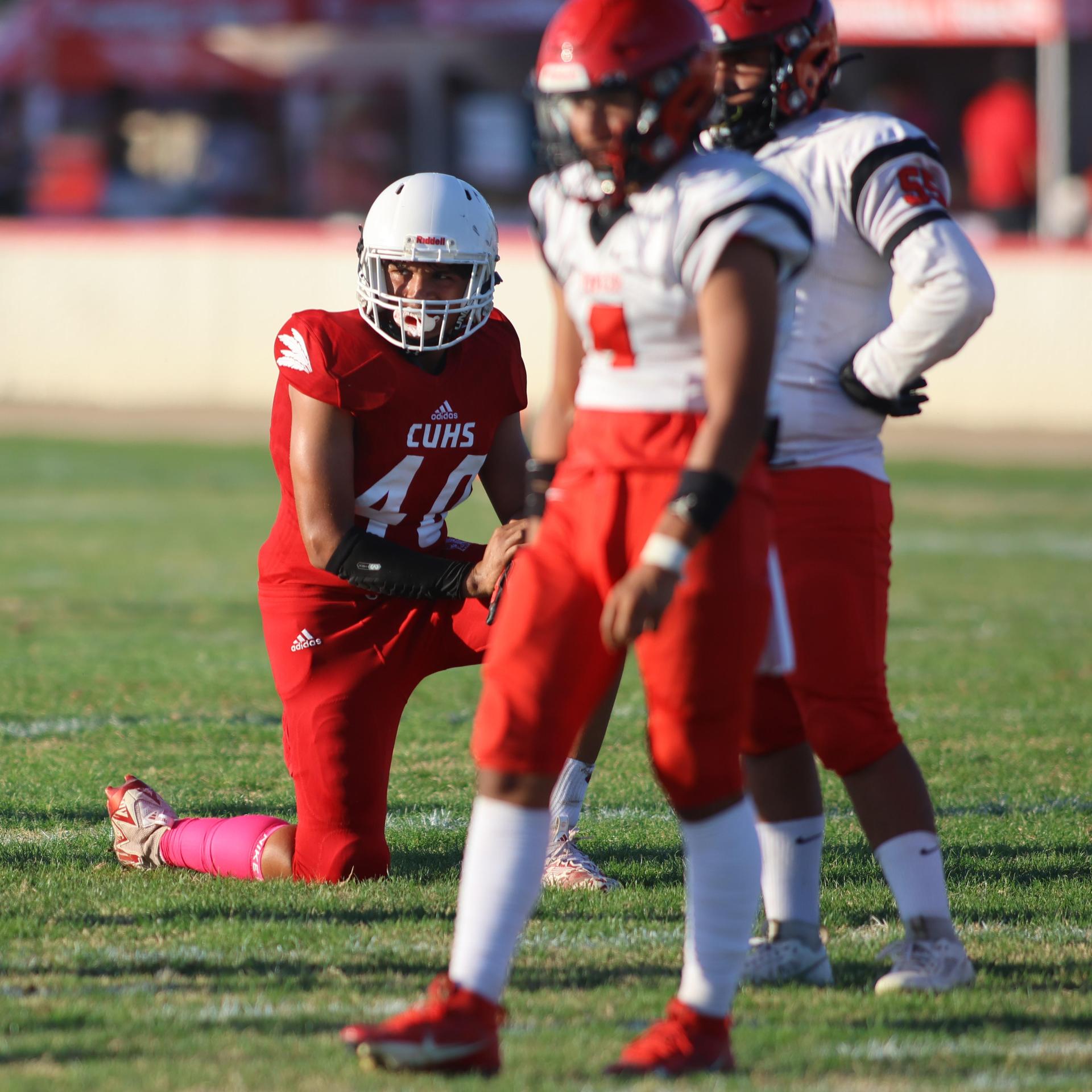 junior varsity football players in action against Fowler