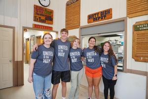 A group of TKHS students worked in the kitchen helping clean and put away items.