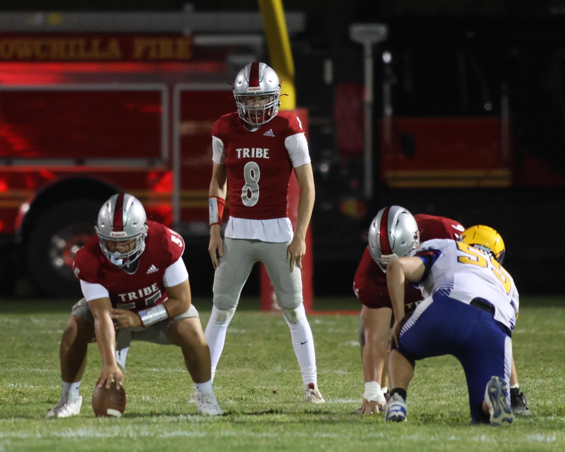 Varsity football players in action against Parlier 158
