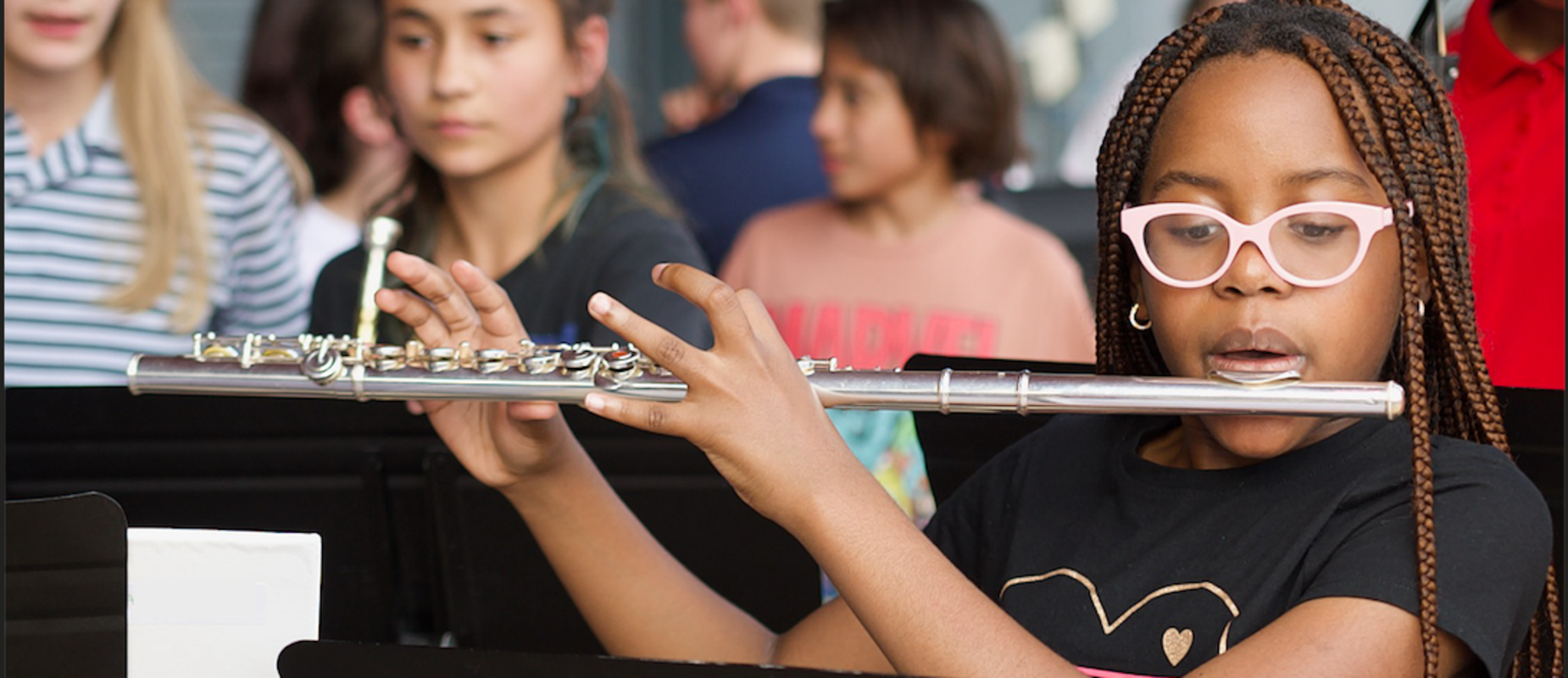 A student practices the flute as they set up for a band performance during Founders Day