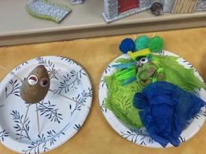 Creative potato figures with various decorative elements on paper plates.