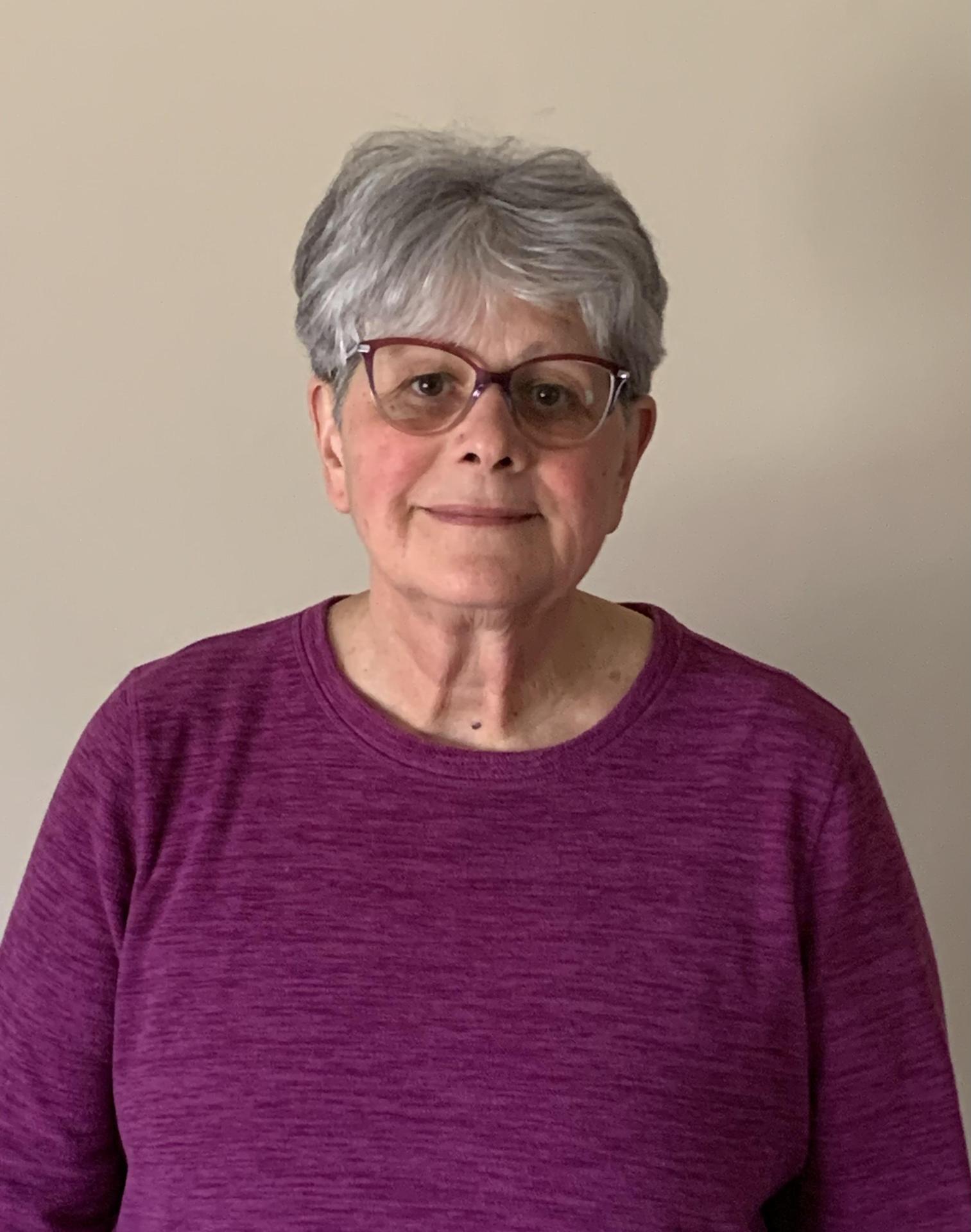 Photo of preschool assistant in purple shirt