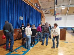 Community members looking at the items on the table.