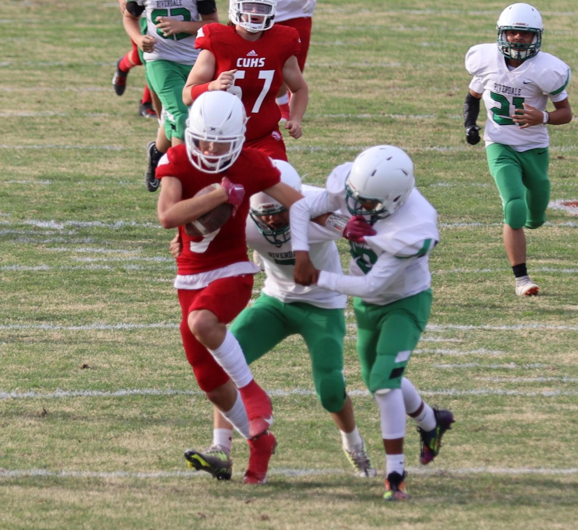  junior varsity football players in action against riverdale