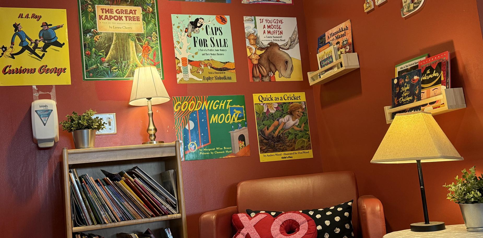 Cozy reading nook with bookshelves and warm lighting.